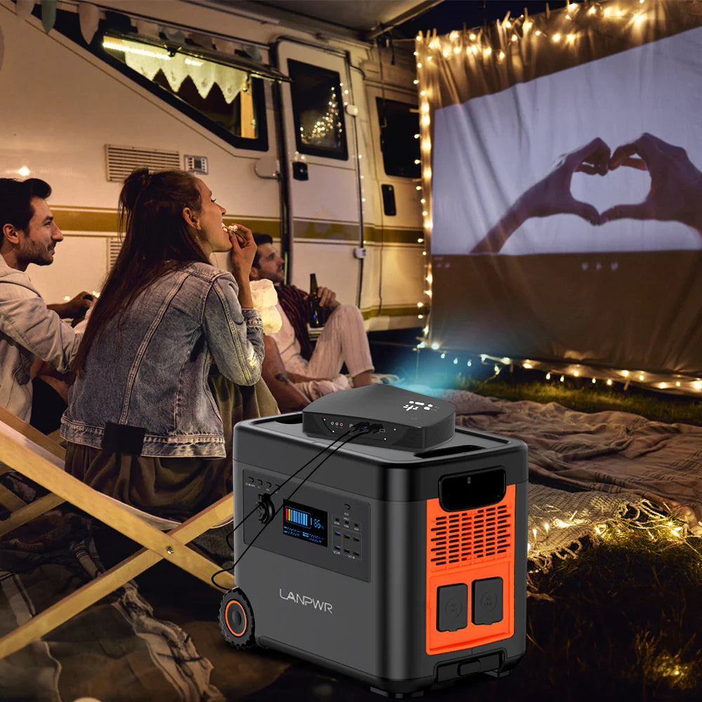 Family using Lanpwr power station to watch a movie at a campsite